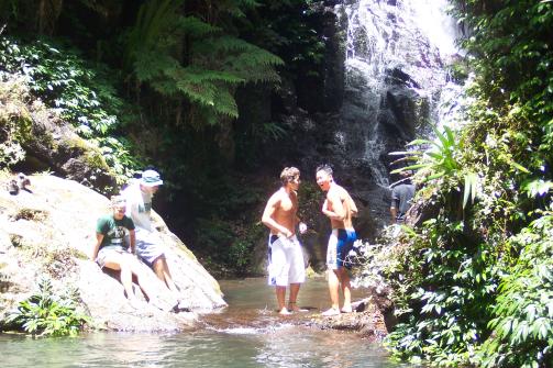 People at base of waterfall