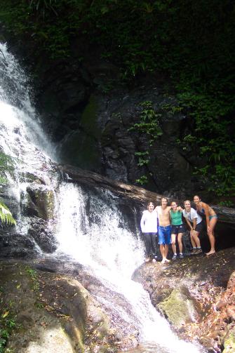 People posing by waterfall