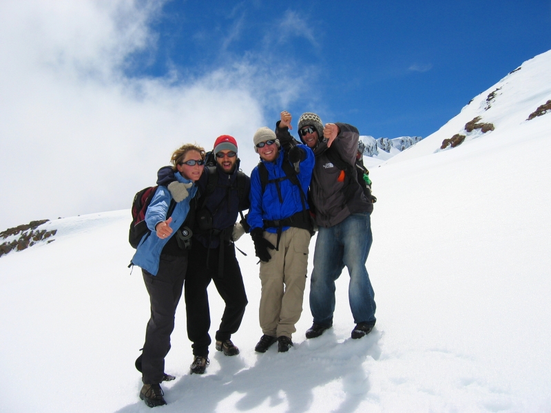  Four people pose on snow