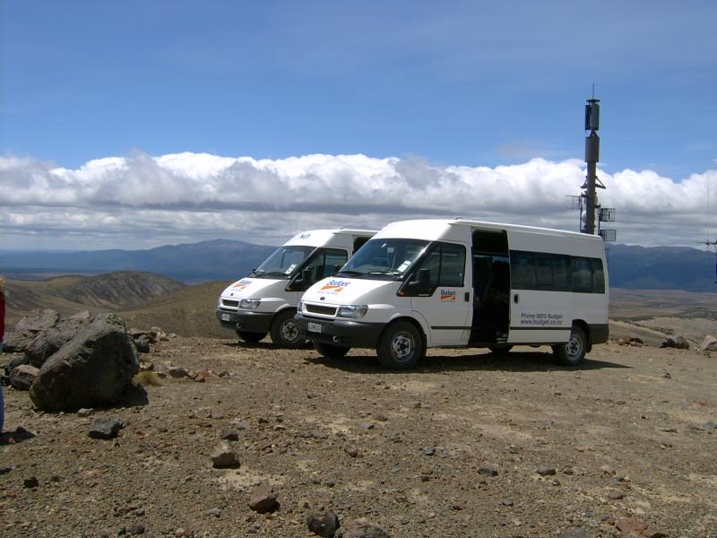 Passenger vans in front of vista and radio antenna.
