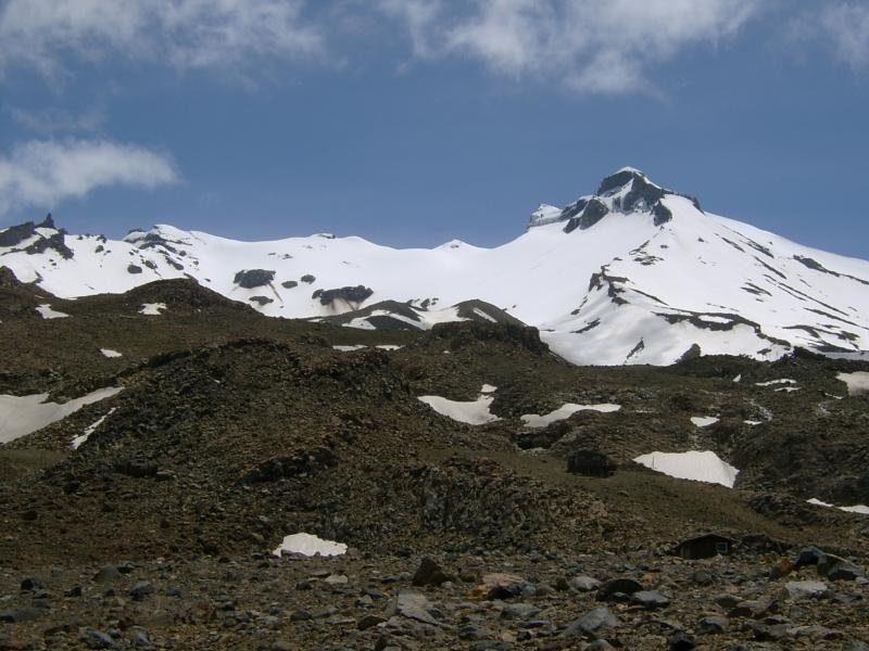  Rough, rocky fore-slopes leading to snowy peaks.