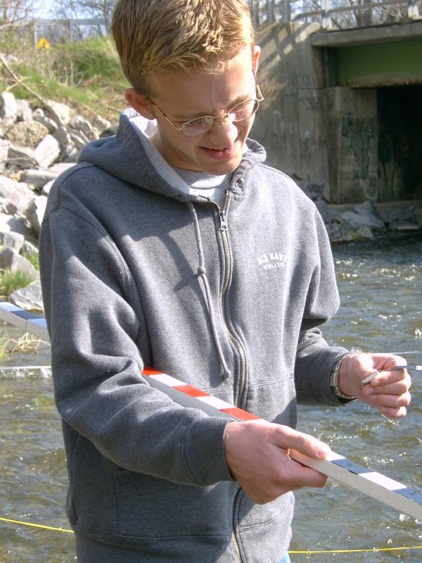 student with flagstaff and tape.