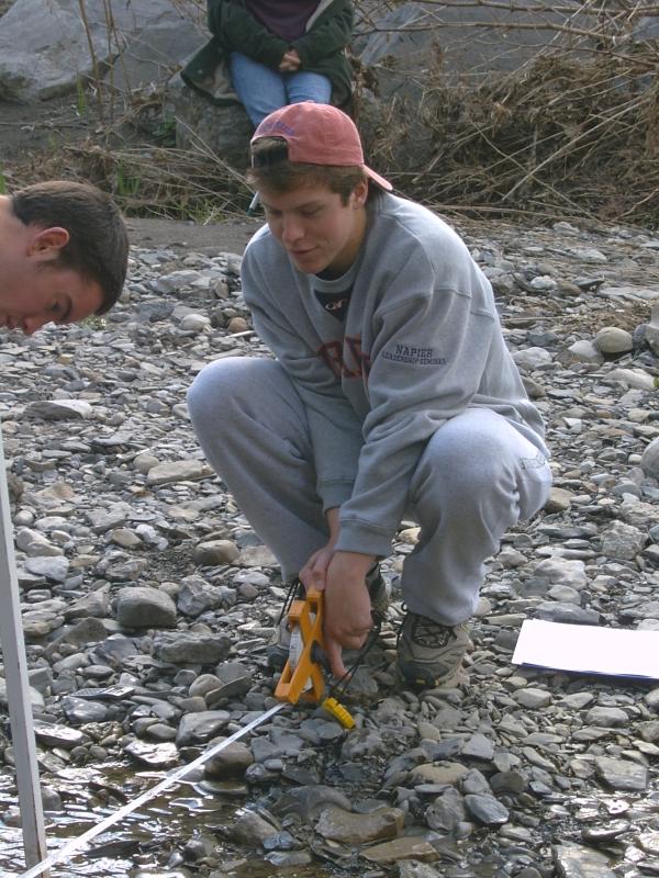 student squatting with tape