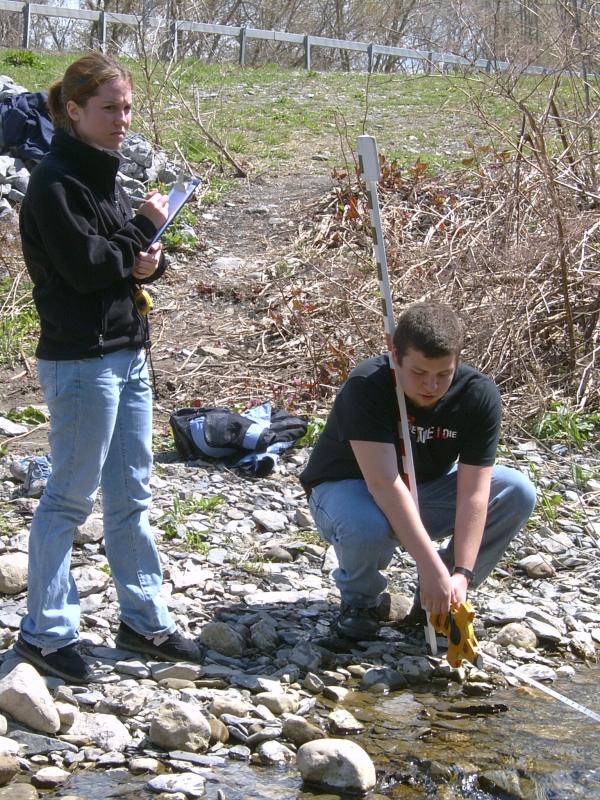 students at stream bank