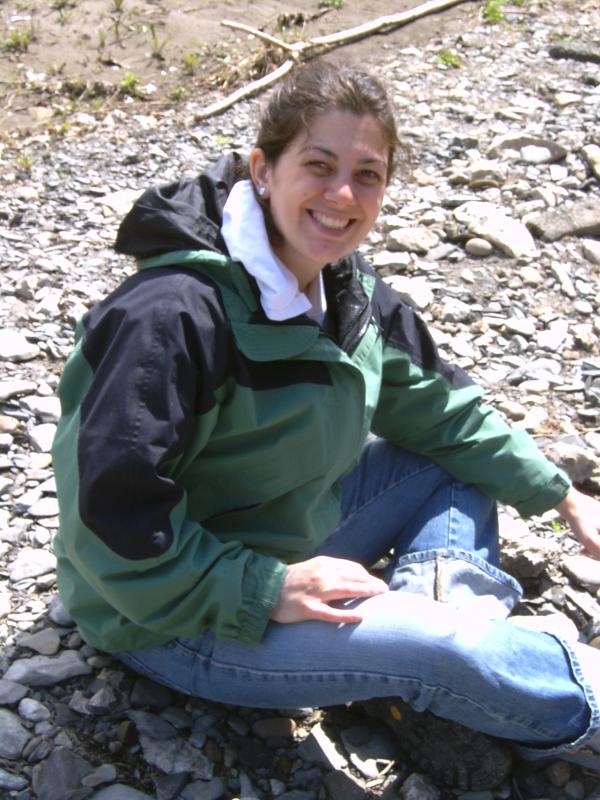 student sitting on gravel bar