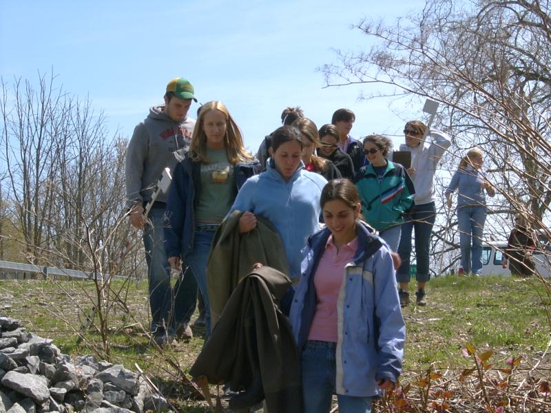 Class walking down stream bank