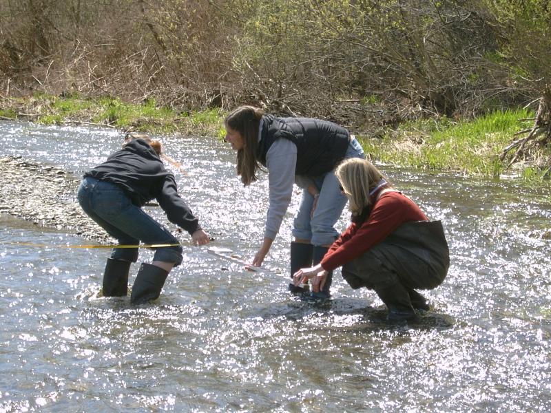 Three students working in stream