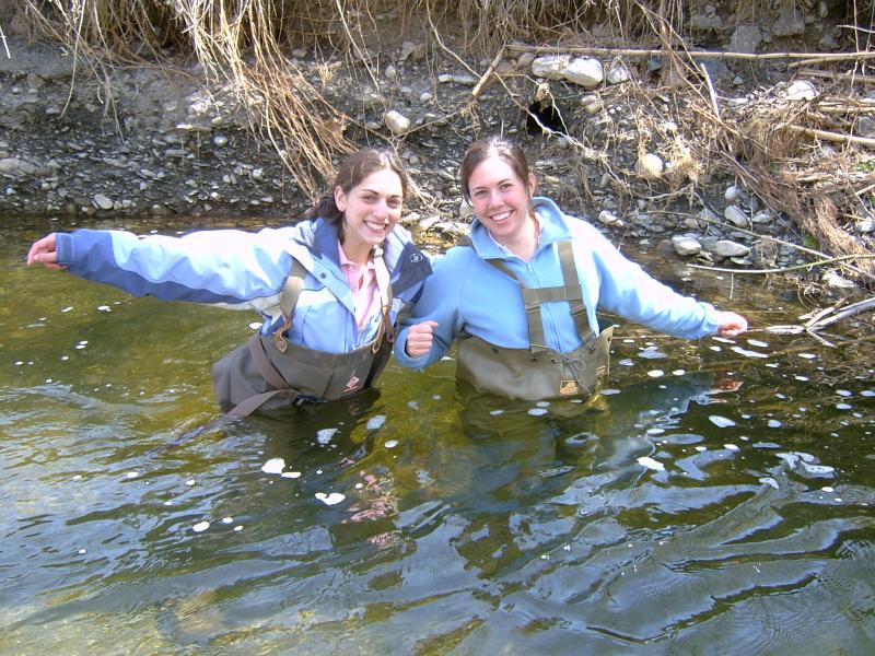 Two students wading in waist-deep water